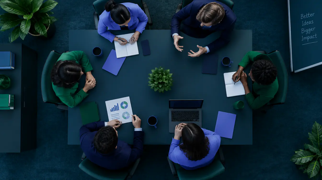Overhead view of a business team meeting around a table with reports and a laptop